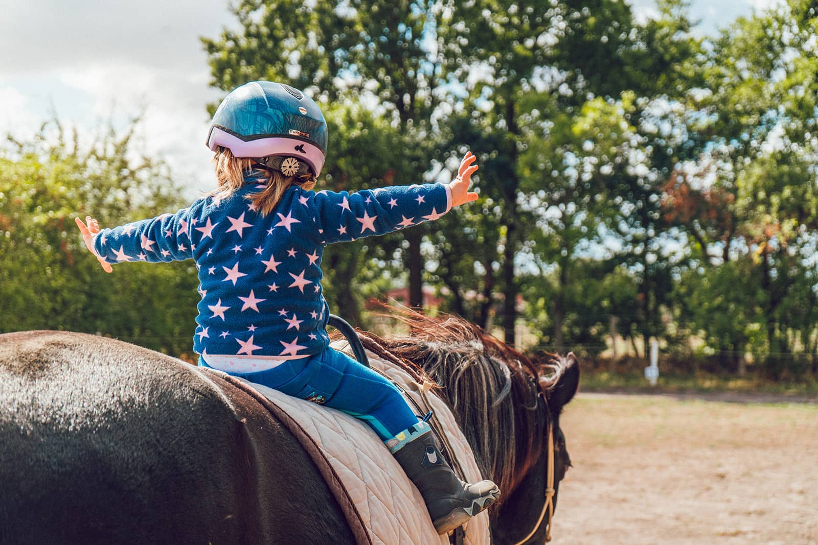 Young girl riding horseback
